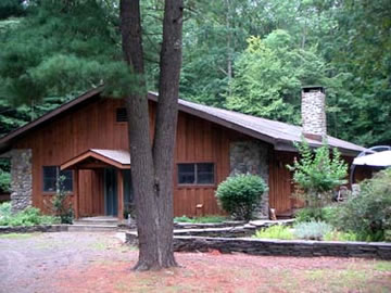 This extraordinary 3500 sq. ft. house is built in a cabin style with a massive stone fireplace as it's central feature.  The kitchen is simple, yet elegant and features a 6 burner Viking stove and an island.  The Master bedroom suite is huge and features it's own den, walk-in closet and full bath.  The house has 3 large bedrooms and 3 baths.  This home is sited beautifully on it's own (already subdivided off) 10 acres and is walking distance to the dock, and swimming and boating area.