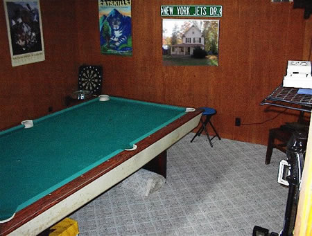 Game room includes pool table.  Has seperate entrance and connects to another room with a bath that could be seperated out as a small apartment or guest suite.